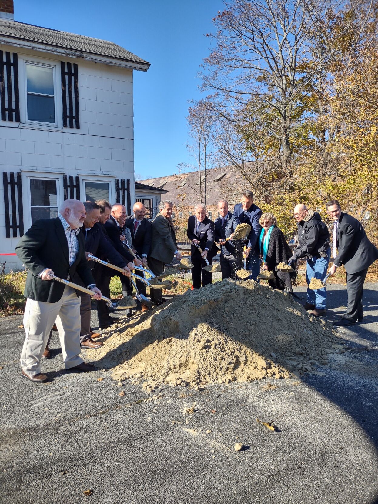 Dignitaries dig shovels into dirt